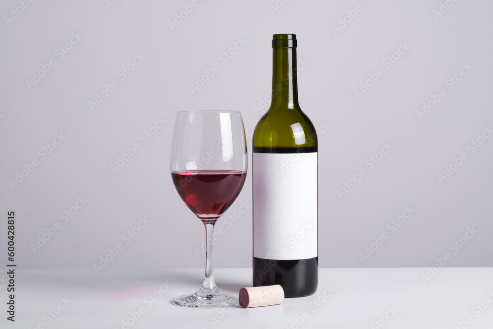 Close up red wine with the glass against gray background. Celebration party restaurant menu with copy space for text. Close up red wine with the glass against gray background. Celebration party restaurant menu with copy space for text.