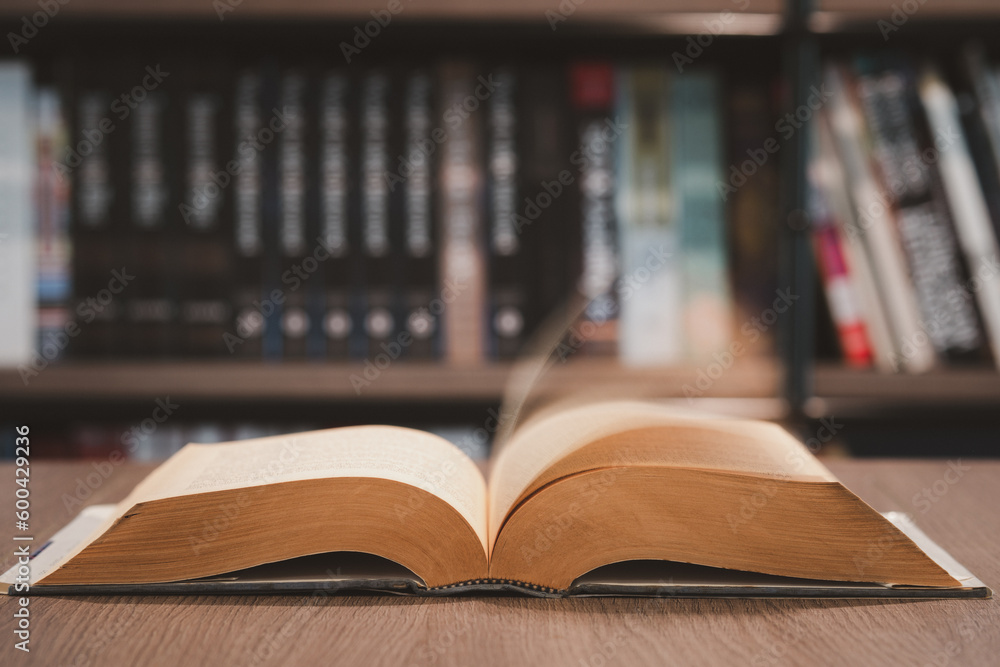 Fototapeta premium Open book on the table in library. Love read a book. Education learn and knowledge concept. Student study in school or university.