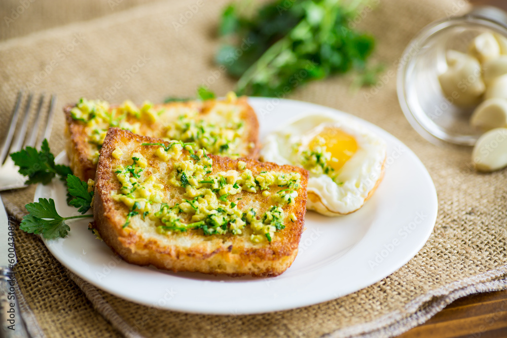 Fried croutons in batter with garlic and herbs in a plate. Fried croutons in batter with garlic and herbs in a plate.