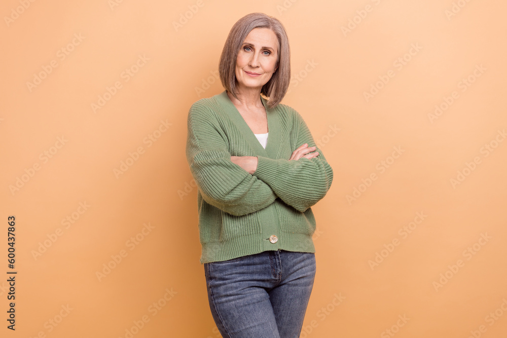 Photo of confident businesswoman senior age crossed arms wear khaki shirt representative office worker isolated on beige color background Photo of confident businesswoman senior age crossed arms wear khaki shirt representative office worker isolated on beige color background