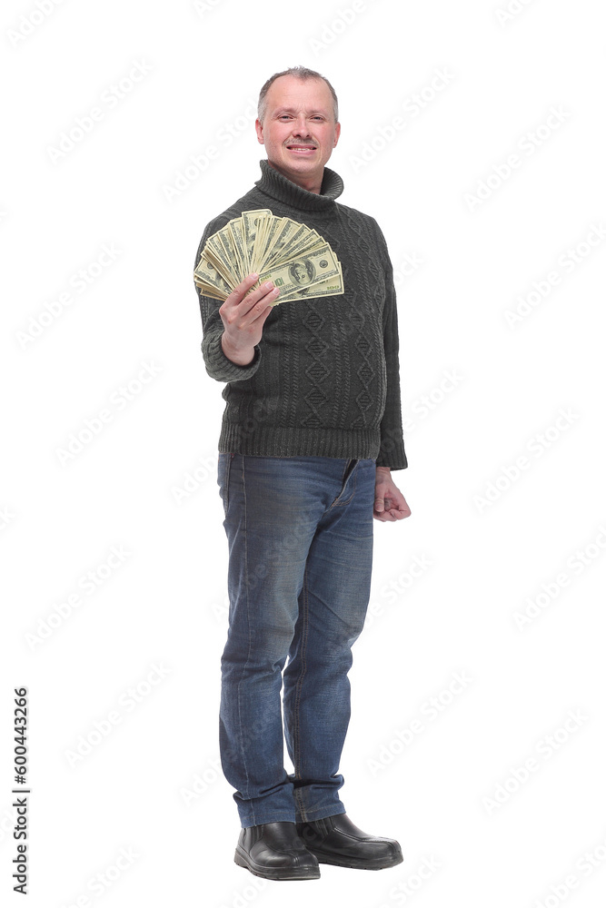 Fototapeta premium Portrait of smiling young man holding fanned US paper currency