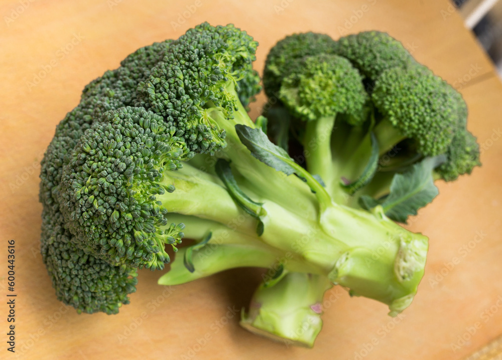 healthy broccoli and florets on wooden board healthy broccoli and florets on wooden board