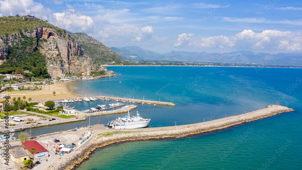 Aerial view of the port of Terracina, near Rome, in the Province of Latina, Italy. There are many boats moored at the marina. In the background are Sant'Angelo mount and the Lazio coast.