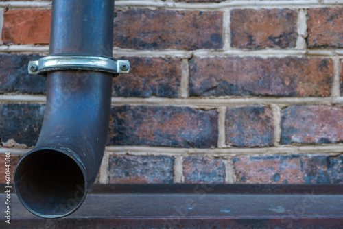 A drainpipe on a brick wall. photo