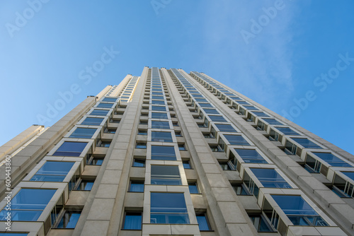 A view from below of a tall building against the sky.