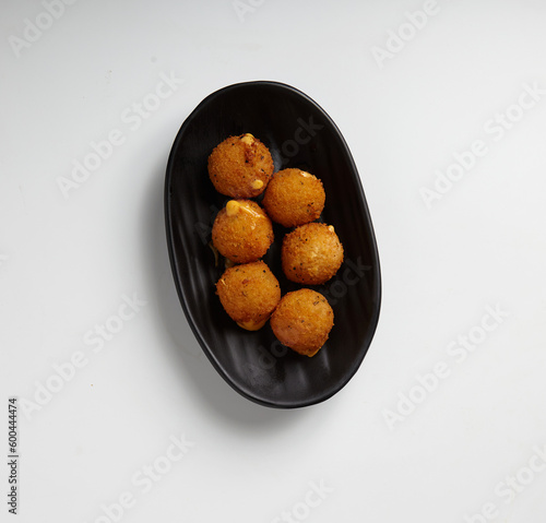 Fried Cheese Balls on a Black Plate White Background Studio Shot