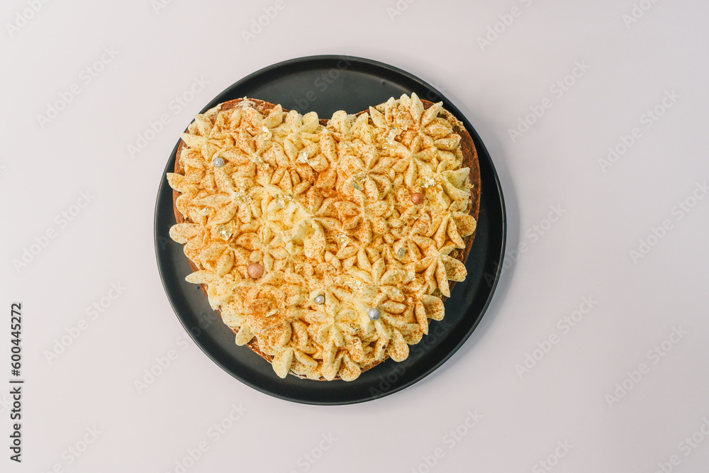 cake for the valentine's day. heart cake with vanilla cream on the black plate cake for the valentine's day. heart cake with vanilla cream on the black plate