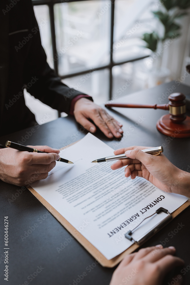 Businessmen and lawyers discuss and read the details of the treaty documents before signing the contract invest in business. Businessmen and lawyers discuss and read the details of the treaty documents before signing the contract invest in business.