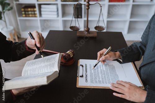 Attorneys or lawyers who are reading the statute of limitations Consultation between male lawyers and business clients, tax and legal and legal services firms. photo