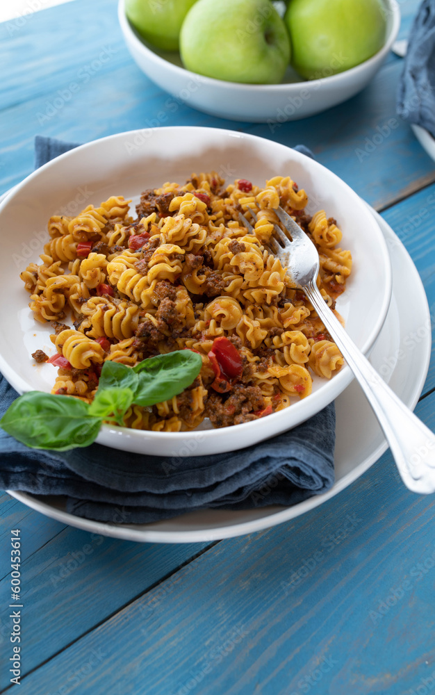 Beef and pasta with chopped bell pepprs, onions, tomatoes, garlic and herbs on a plate Beef and pasta with chopped bell pepprs, onions, tomatoes, garlic and herbs on a plate