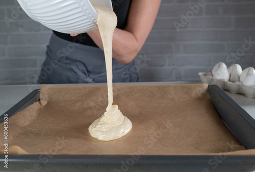Pouring batter on a baking sheet. Freeze motion
