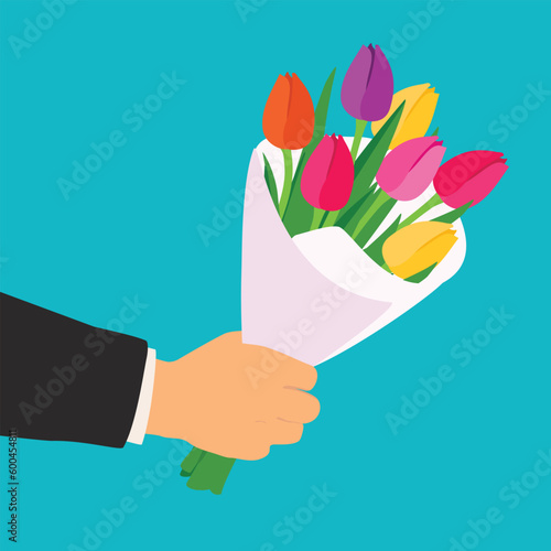 Arm holding colorful bouquet for woman.