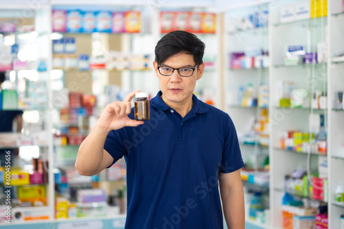 Pharmacy Drugstore. Portrait handsome man buy medicine at pharma store. Health and wellness center