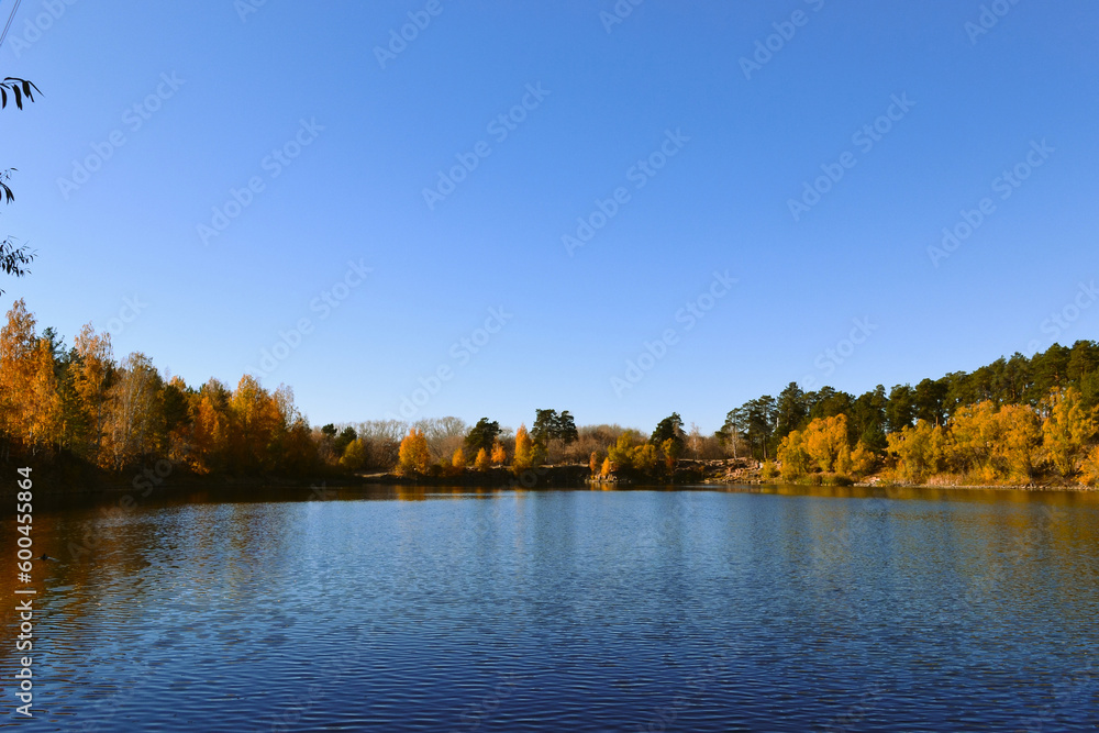 Autumn trees on the shore of a forest lake Autumn trees on the shore of a forest lake