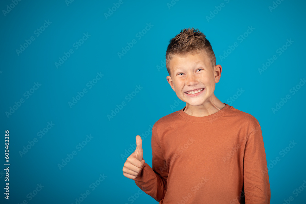 Funny Preteen Boy Showing Thumb Up And Grimacing At Camera Funny Preteen Boy Showing Thumb Up And Grimacing At Camera
