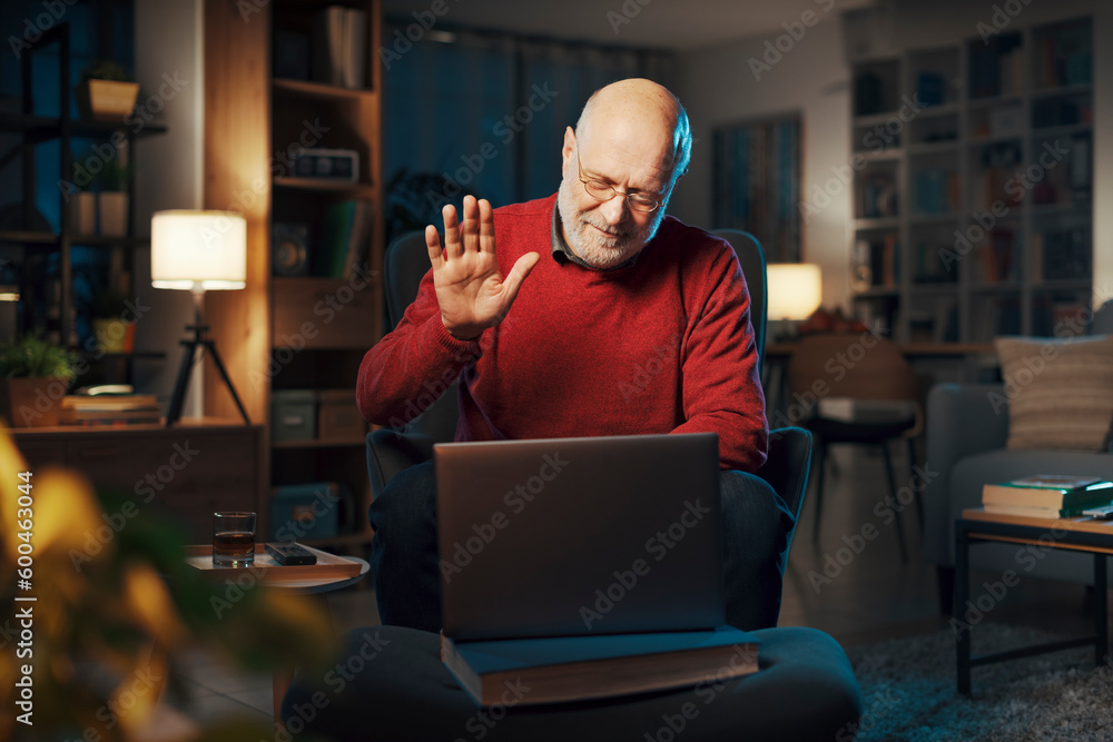 Senior man using a laptop at home Senior man using a laptop at home