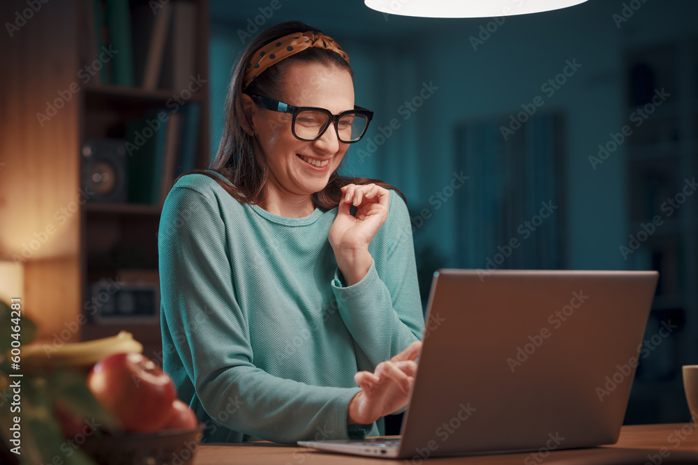 Happy woman connecting online and smiling Happy woman connecting online and smiling