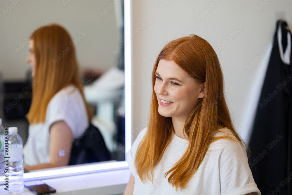 Portrait happy female customer at the hair salon. Professional hairdresser blow drying with hairdeyer to female customer in hair salon. Portrait happy female customer at the hair salon. Professional hairdresser blow drying with hairdeyer to female customer in hair salon.