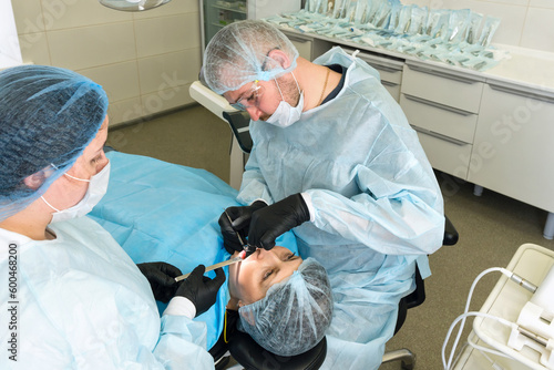 Surgeon and nurse during dental operation