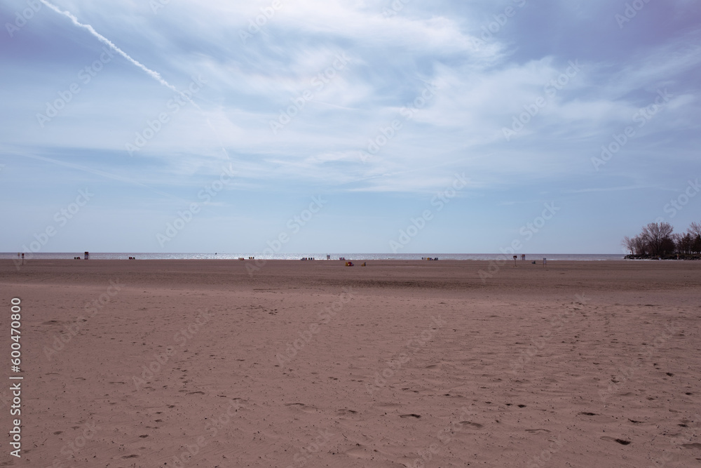 view of a beach with brown sand and blue sky