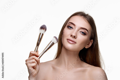 attractive woman with make-up brush for powder