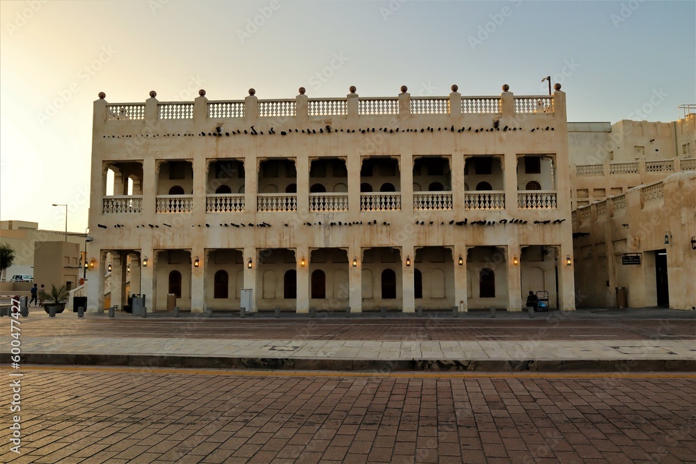 Naklejka premium Souq Waqif, Doha, Qatar, 4.27.2023, Traditional Arabian building built of wood and mud decorated with a facade in the traditional Arabic style. Arabian Gulf, Middle East.