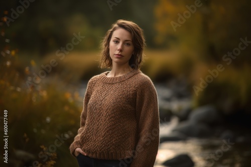 Portrait of a beautiful young woman in the autumn forest. Soft focus.