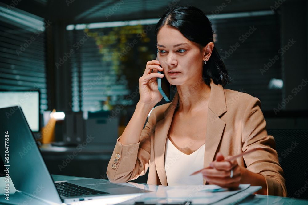Businesswoman talking on phone with colleague from another country, time difference concept Businesswoman talking on phone with colleague from another country, time difference concept