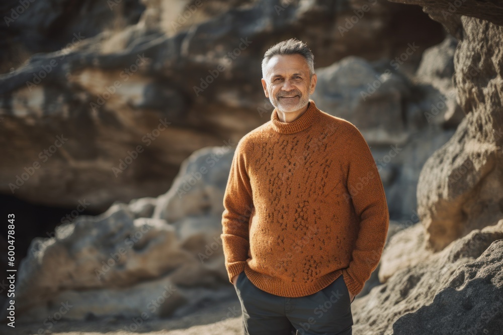 Portrait of a handsome middle-aged man in a sweater on the beach Portrait of a handsome middle-aged man in a sweater on the beach