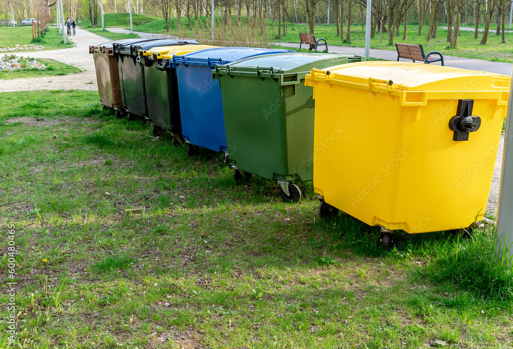 Black, blue, yellow, green garbage recycling bins on street in city. Separate waste, recycling environment concept. Segregate waste, sorting garbage. Colored trash cans with paper, glass, plastic Black, blue, yellow, green garbage recycling bins on street in city. Separate waste, recycling environment concept. Segregate waste, sorting garbage. Colored trash cans with paper, glass, plastic