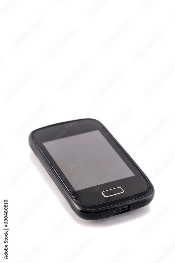 Old black mobile phone isolated on white background. Focus on the screen. Old black mobile phone isolated on white background. Focus on the screen.