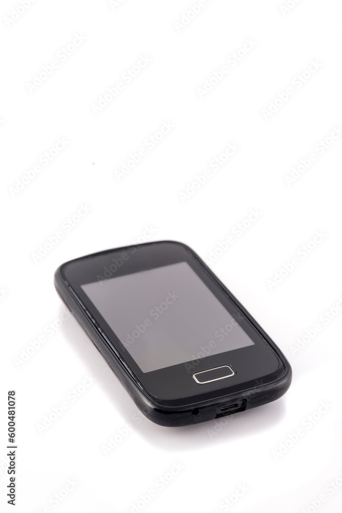Old black mobile phone isolated on white background. Focus on the screen. Old black mobile phone isolated on white background. Focus on the screen.