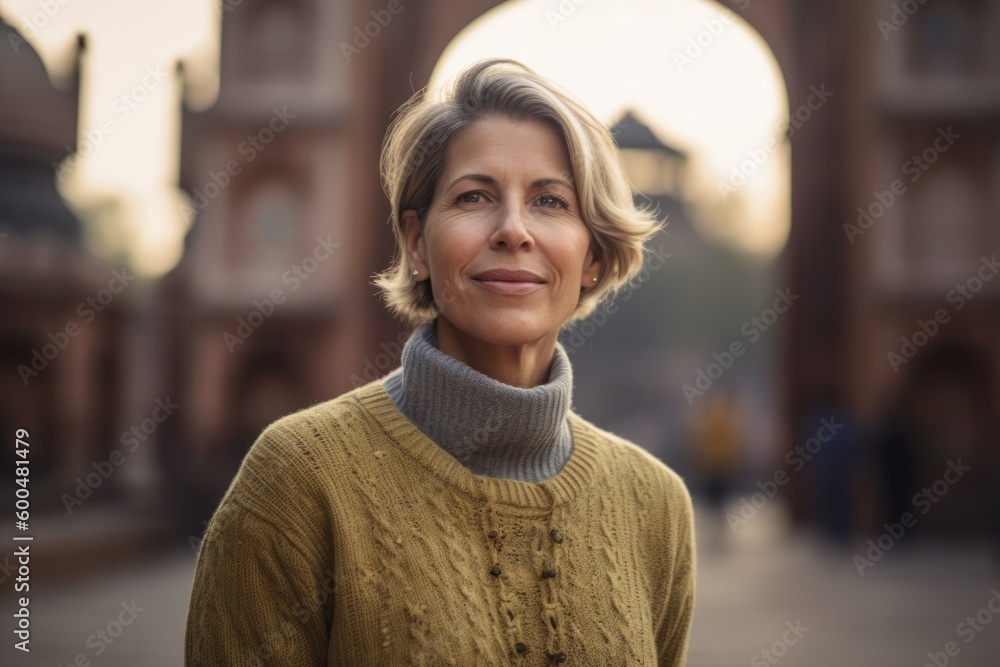 Portrait of a beautiful middle-aged woman in a yellow sweater