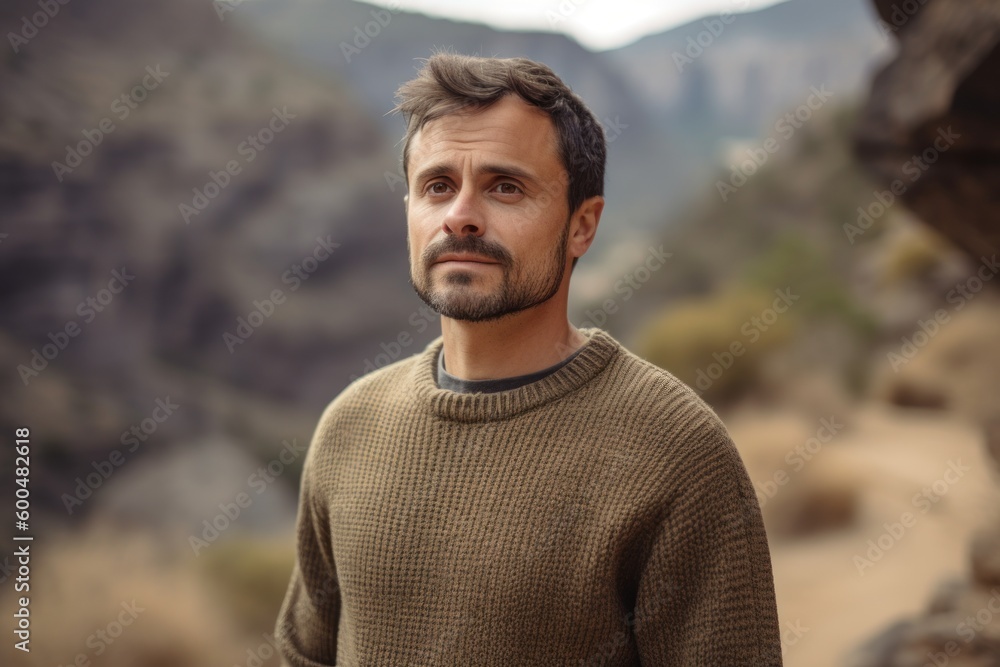 Portrait of a handsome man in the mountains. Men's beauty, fashion.