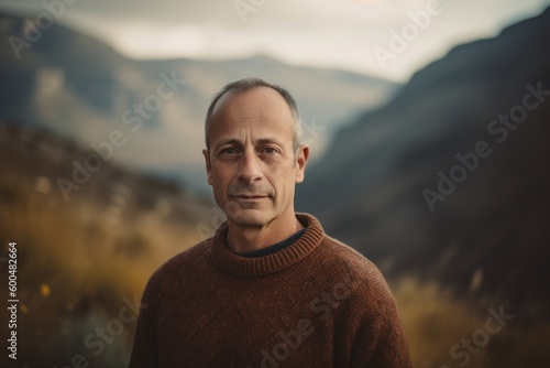 Portrait of a middle-aged man in the mountains. Toned.