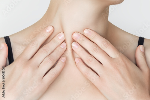 woman massaging her neck and clavicular mastoid muscle (Sternomastoid Muscle, Stemocleidomastoid Muscle). wellness self-massage at home concept