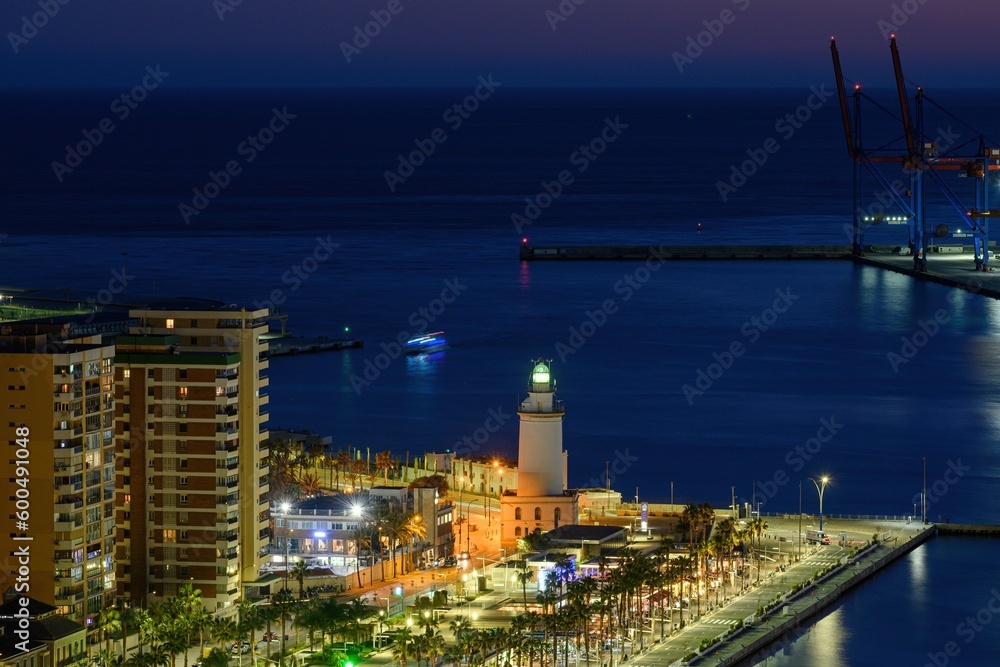 MALAGA, SPAIN - March 08, 2023. Lighthouse Farola in Malaga port