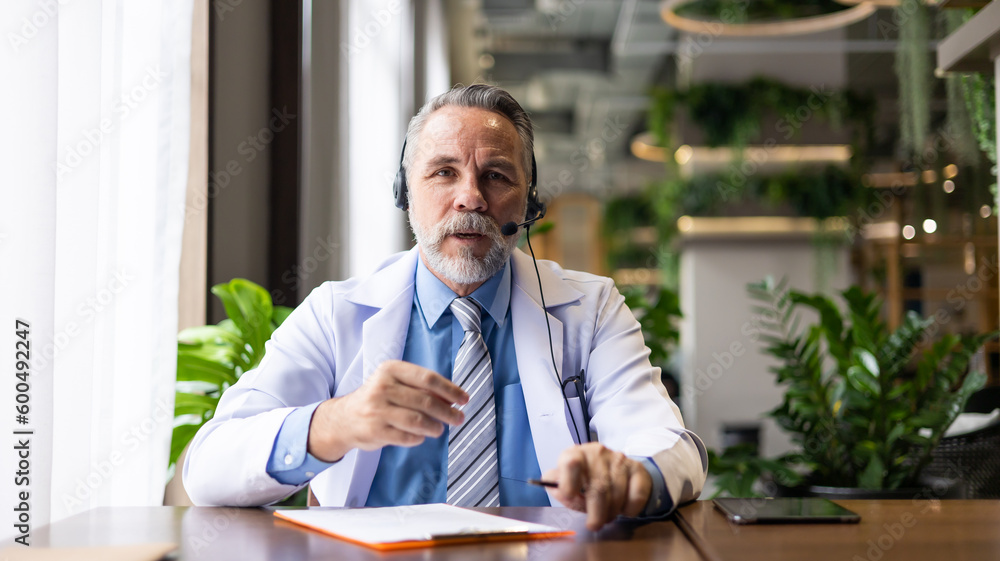 Senior caucasian doctor online video call conference consult patient on laptop computer. Doctor online consultation and telehealth medicine Senior caucasian doctor online video call conference consult patient on laptop computer. Doctor online consultation and telehealth medicine