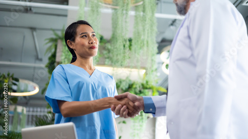 Surgeon medical and doctor people handshaking. Asian woman nurse shaking hands with doctor on a business cooperation agreement. healthcare and medicine
