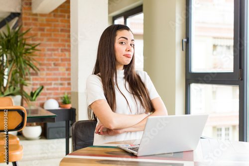 pretty young woman with a laptop working at home. house interior design