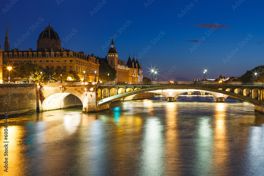 Night view with Seine river and bridge in Paris, France, Europe