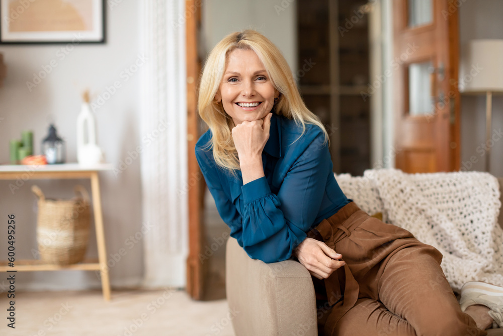 Blonde Lady Enjoying Mature Life Posing On Couch At Home