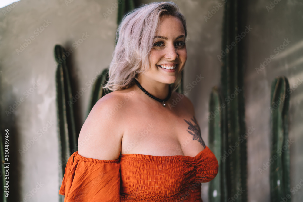 Fototapeta premium Happy woman with long hair looking at camera