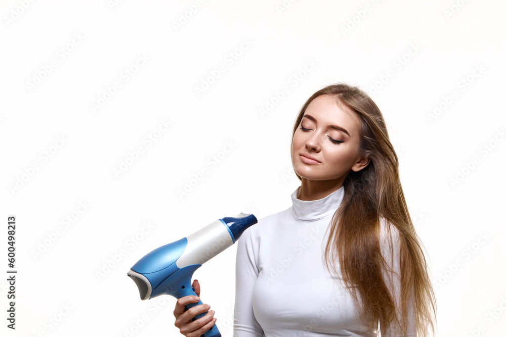 Portrait of attractive cheerful girl drying long hair Portrait of attractive cheerful girl drying long hair