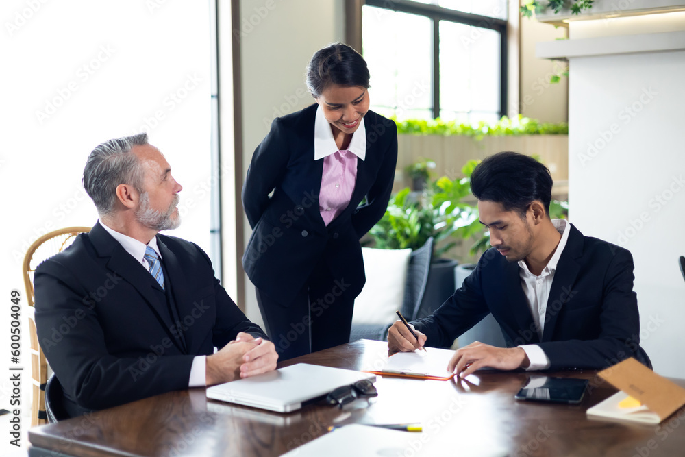Business contract and agreement concept. Senior business man and young business asian man signing contract for investment or buy estate and insurance Business contract and agreement concept. Senior business man and young business asian man signing contract for investment or buy estate and insurance
