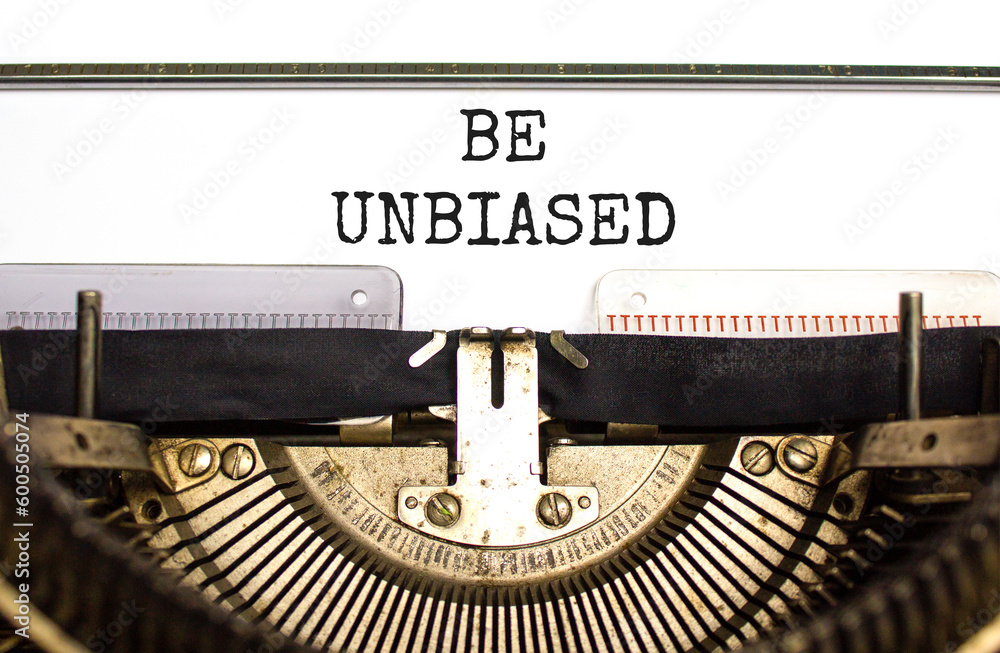 Be unbiased symbol. Concept words Be unbiased typed on white paper on old retro typewriter. Beautiful white background. Business psychology be unbiased concept. Copy space.