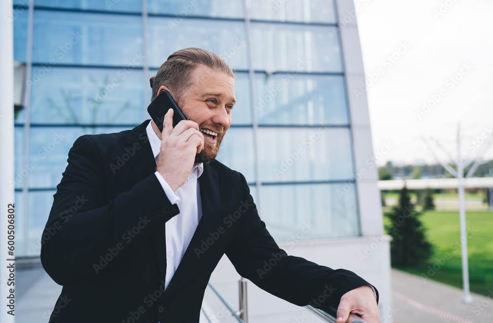 Glad businessman talking on smartphone Glad businessman talking on smartphone