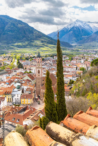 View over cityscape with Cathedral Saint Nikolaus of Merano, South tyrol, Italy seen from famous hiking trail Tappeinerweg