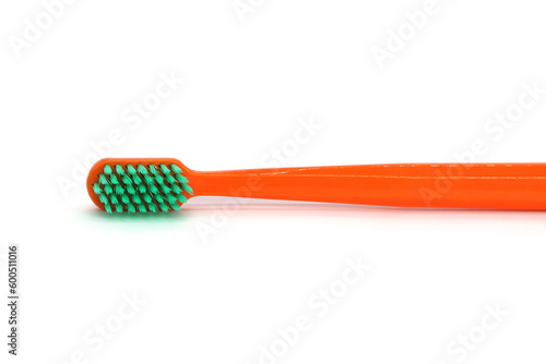 orange toothbrush close-up on a white background