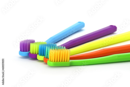 top view of colorful toothbrushes on light color background